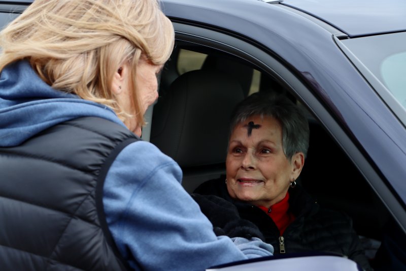 Sandy Muir of Milton is the first to take advantage of this year’s ashes-to-go event at Zion United Methodist Church. Muir talks with Pastor Pat Bollinger on the side of Broadkill Road.